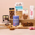 Hot chocolate and sweet treats hamper with cakes, biscuits and macarons