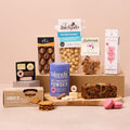 Hot chocolate and sweet treats hamper with cakes, biscuits and macarons