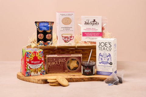 Festive Christmas hamper with mince pies, biscuits, truffles and tea