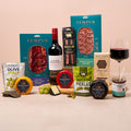 Cheese, red wine and charcuterie hamper with crackers, olives and chutney