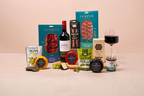 Cheese, red wine and charcuterie hamper with crackers, olives and chutney