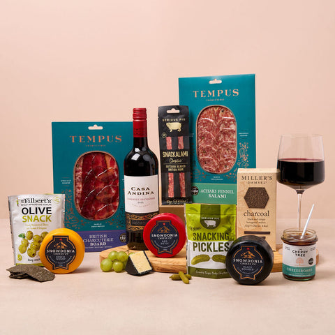Cheese, red wine and charcuterie hamper with crackers, olives and chutney