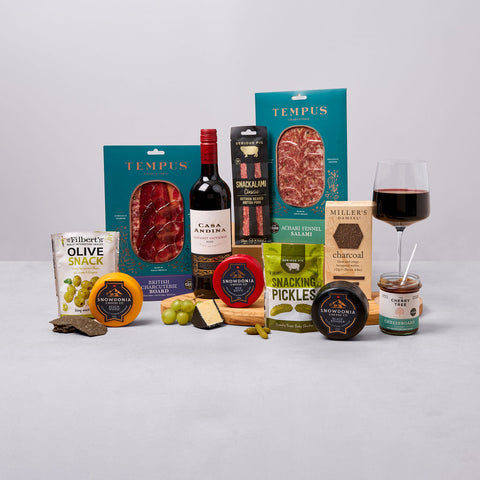 Cheese, red wine and charcuterie hamper with crackers, olives and chutney